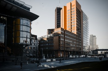 Brown Building Near Orange Painted Building