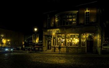 Brown Building With Yellow Lights at Night