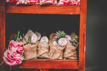 Brown Burlap Wrapped Party Favors on Brown Wooden Rack