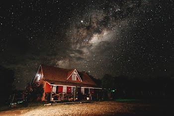 Brown Cabin Photo during Starry Nighttime