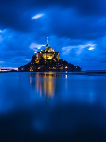 brown castle on body of water