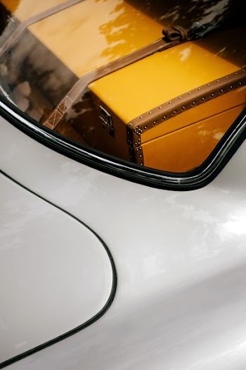 brown chest box inside silver car