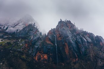 brown cliff during foggy season