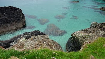 Brown Cliff Near Calm Body of Water