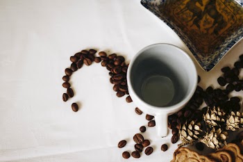 Brown Coffee Beans Near White Ceramic Mug