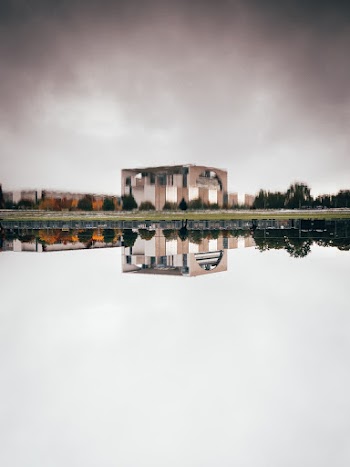Brown Concrete Building Near Body of Water