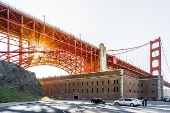 brown concrete building under bridge