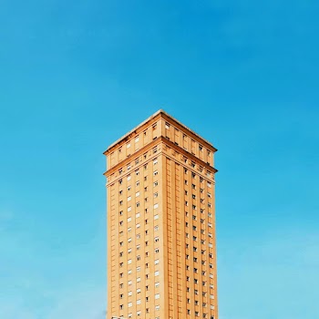 Brown Concrete Building Under Clear Blue Sky