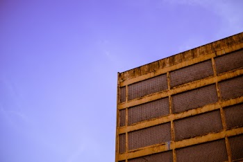 Brown Concrete Building Under Purple Skies
