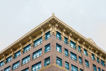 Brown Concrete Building With Blue Painted Windows