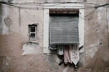brown concrete building wth closed window