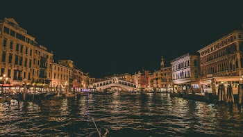 Brown Concrete Buildings Beside Water