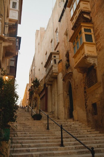 Brown Concrete Buildings With Stairs