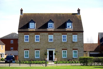Brown Concrete House Near Black Car