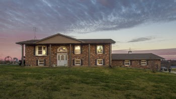 Brown Concrete House Under Gray Clouds