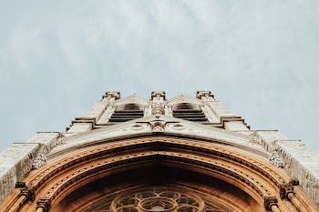 brown concrete structure under cloudy sky