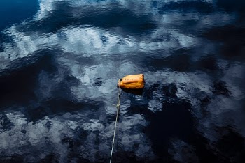 Brown Container Floating on Water