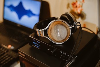 brown corded headphones on black electric device