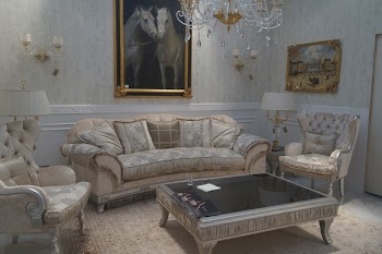 Brown Couch Under Two Horses Painting