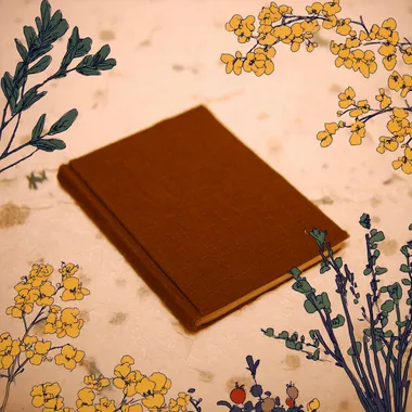Brown Cover Book on Floral Background Brown Cover Book on Floral Background
