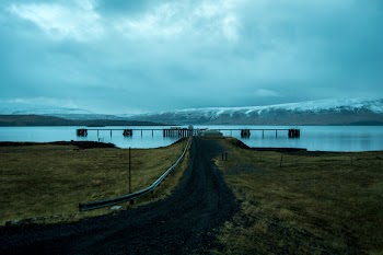 Brown Dock Near Snow Mountain at Daytime