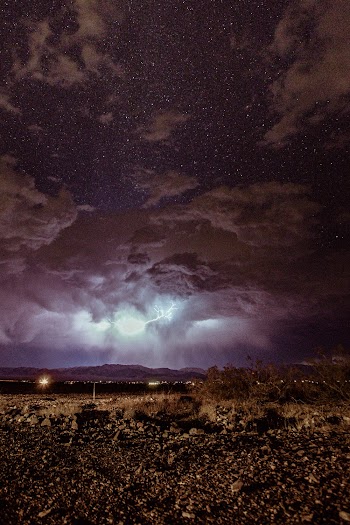 Brown Field Under Cloudy Sky at Night