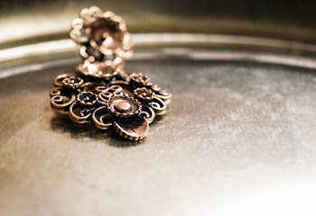 Brown Floral Embossed Metal Decor on Brown Surface