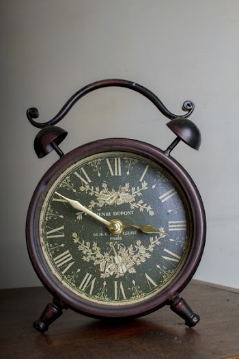 Brown Framed Alarm Clock on Brown Table