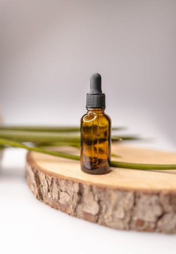 Brown glass bottle for essential oil on decorative wooden board