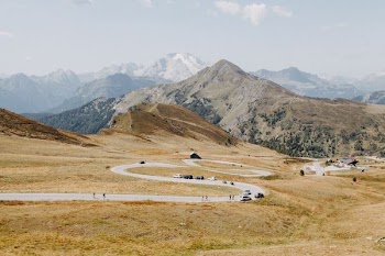 brown grass field near mountain range
