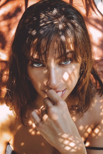 Brown-haired Woman Holding Lips