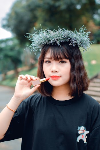 Brown Haired Woman in Black Crew-neck Top Holding Pink Lipstick