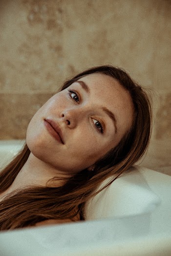 Brown-haired Woman Lying on Bathtub