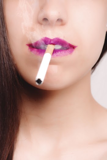 Brown Haired Woman With Pink Lipstick Biting White Cigarette Stick