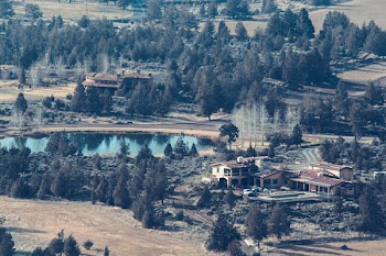 Brown House Near Lake Surrounded by Trees