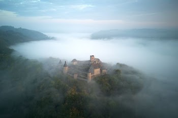 brown house surrounded with fog
