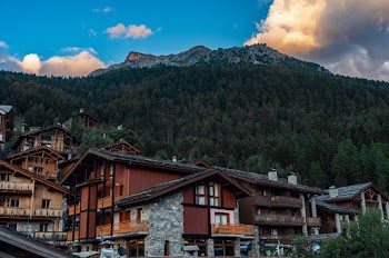 Brown Houses Beside Mountain Under Blue Sky
