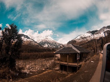 Brown Hut Surrounded With Alp Mountains