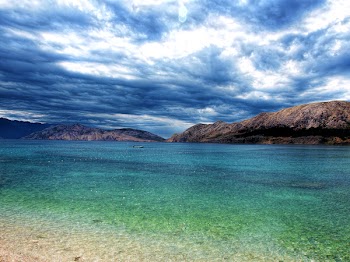 Brown Island Surrounded by Body of Water