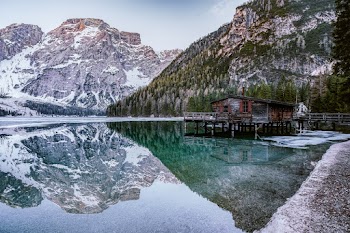 Brown Lakeside Cottage Beside Rocky Mountain
