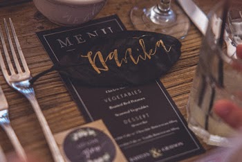 Brown Leaf With Text Placed over the Menu Between Glass Cup and Fok