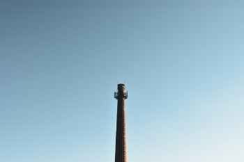 Brown Lighthouse Under Teal Sky