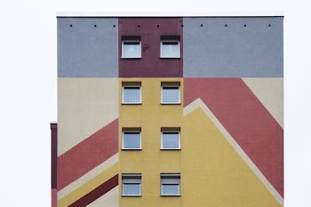 brown, maroon, and gray building at daytime