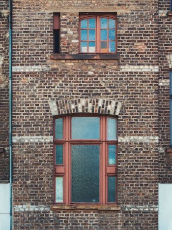 brown metal framed glass window of building