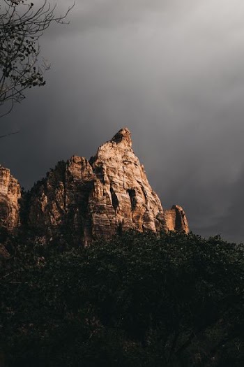 brown monolith in gray cloud background