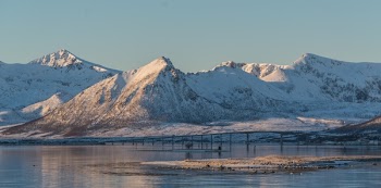 Brown Mountain Covered by Snow Under Gray Sky