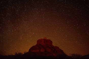 brown mountain under starry sky during nighttime in timelapse photography