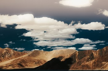 Brown Mountain Under White Clouds