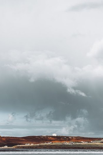 brown mountain under white cloudy sky