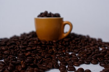 Brown Mug Filled With Coffee Beans
